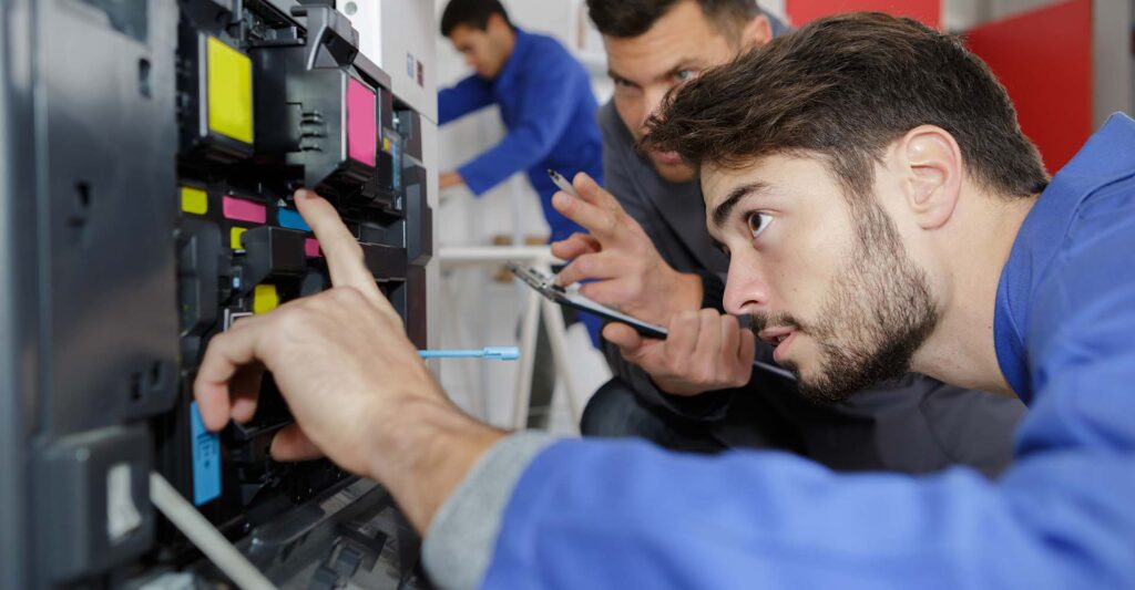 A man working on a printer