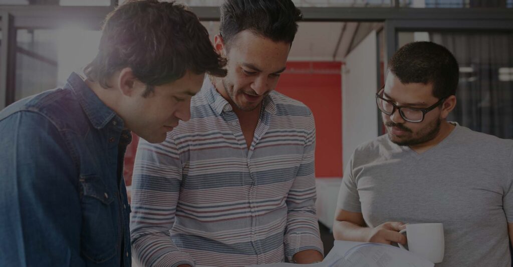 A few people standing together reading