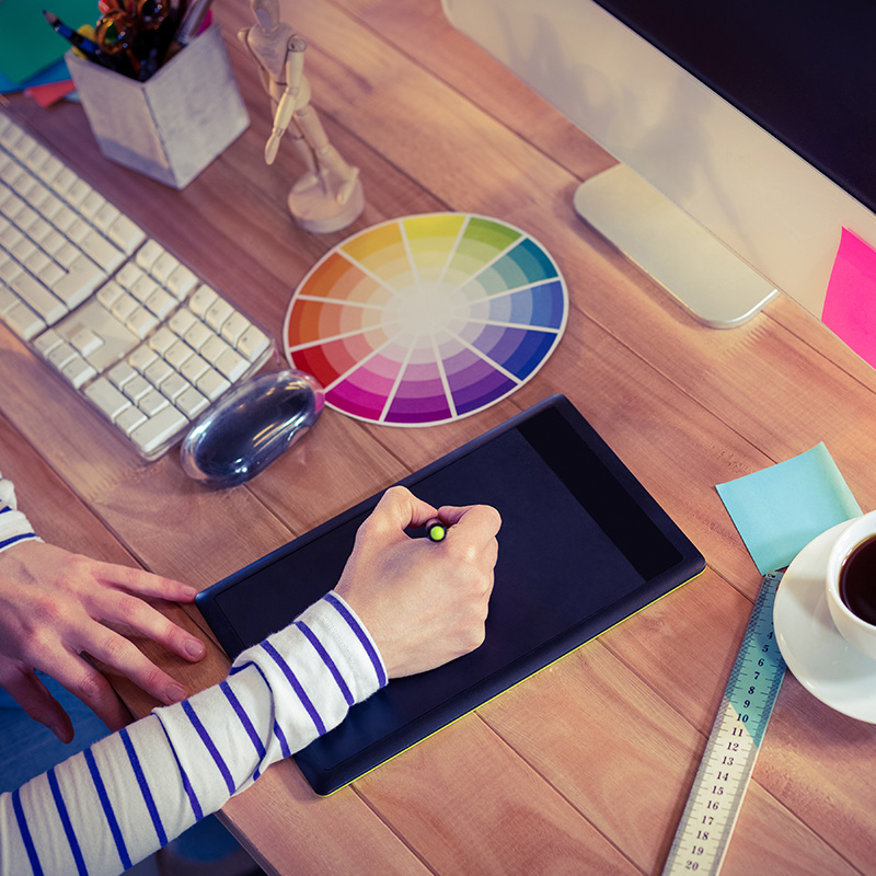 drawing on computer tablet, color wheel on desk