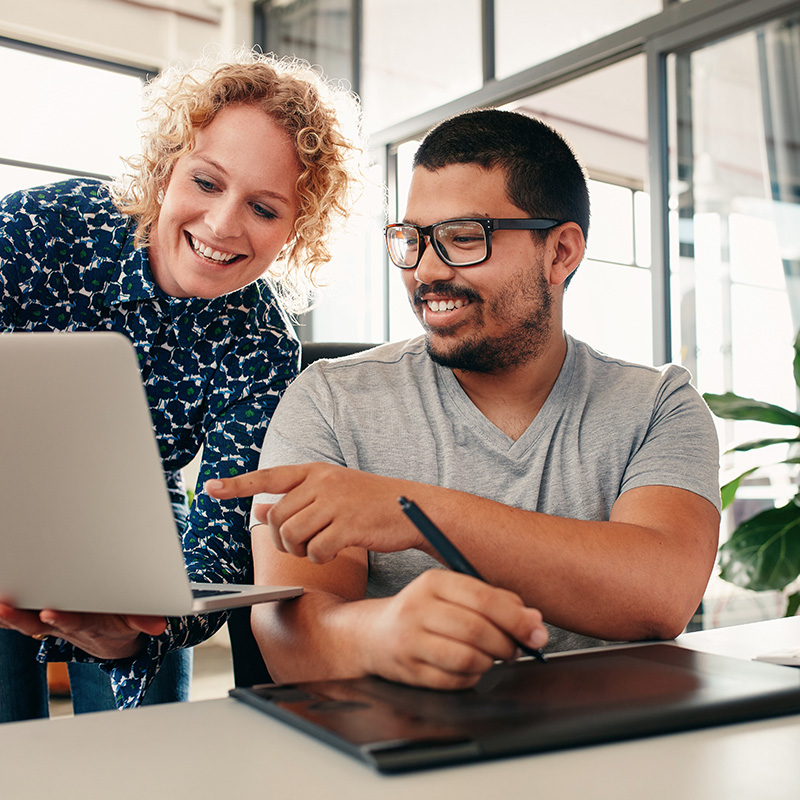 graphic designers pointing at laptop screen
