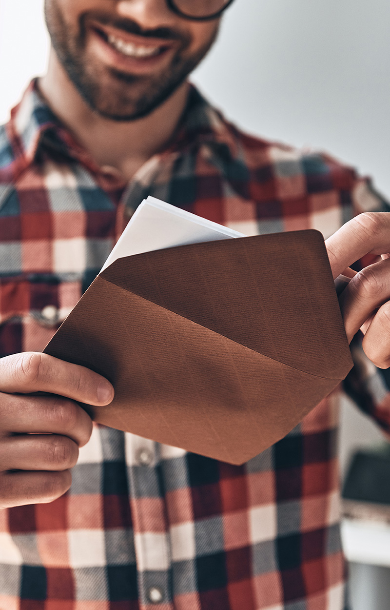 opening envelope, smiling