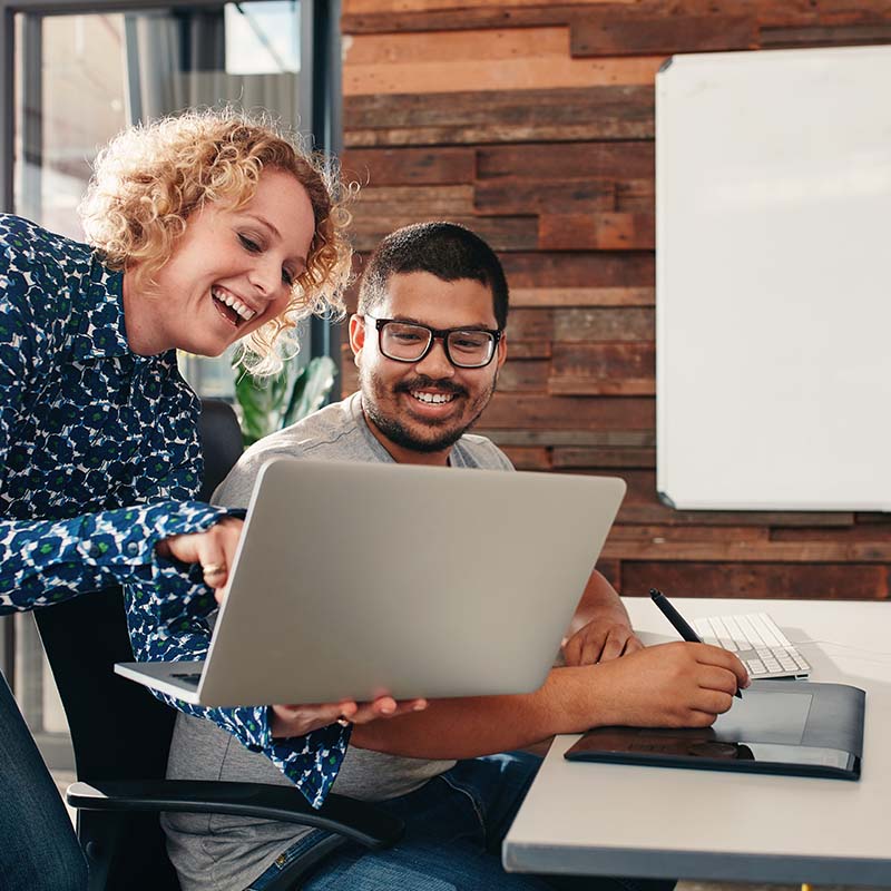 designers and/or client looking at computer smiling
