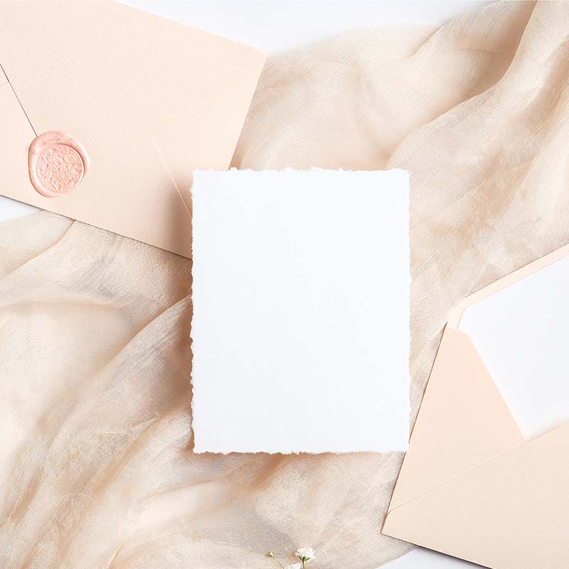 pink envelope with wax seal, handmade/rough-edged stationery