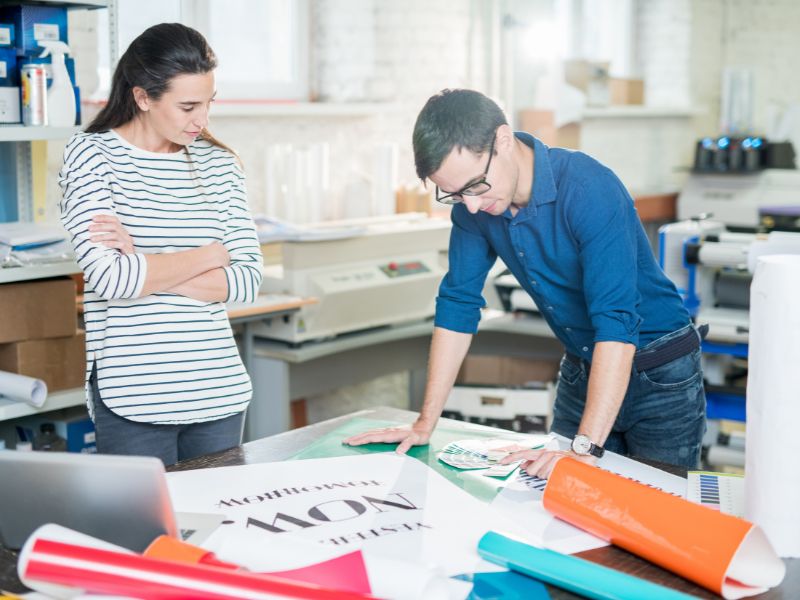 printer talking to client about note card design