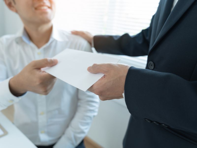 handing over envelop