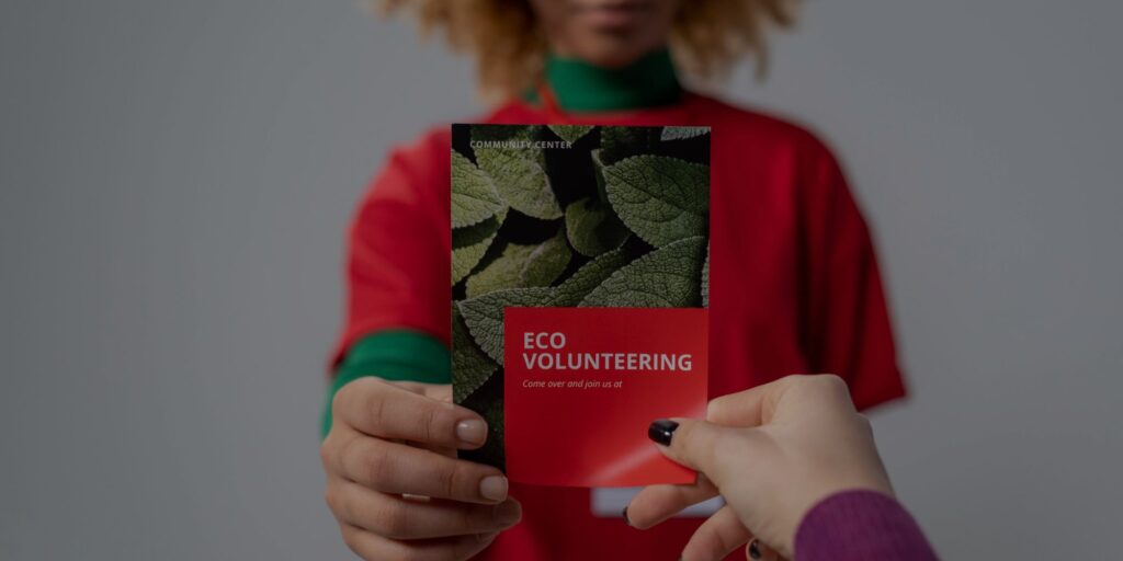 handing out a volunteer flyer