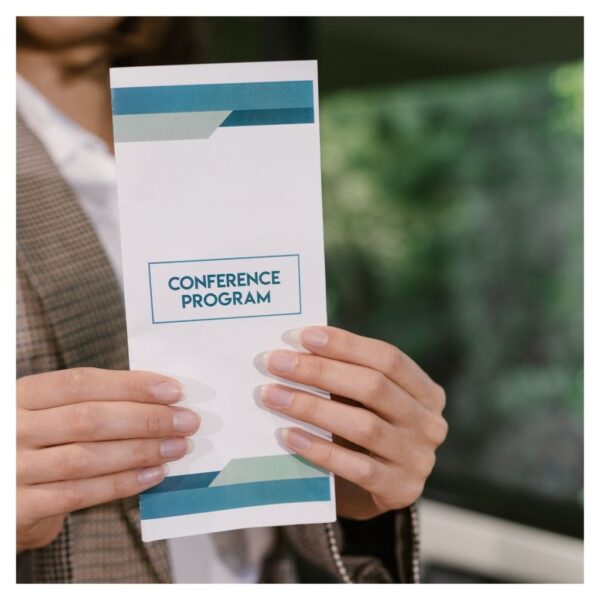 holding up a trifold brochure