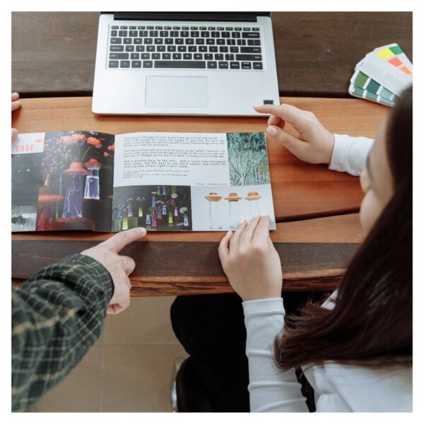 Coworkers Discussing about the Brochure Design