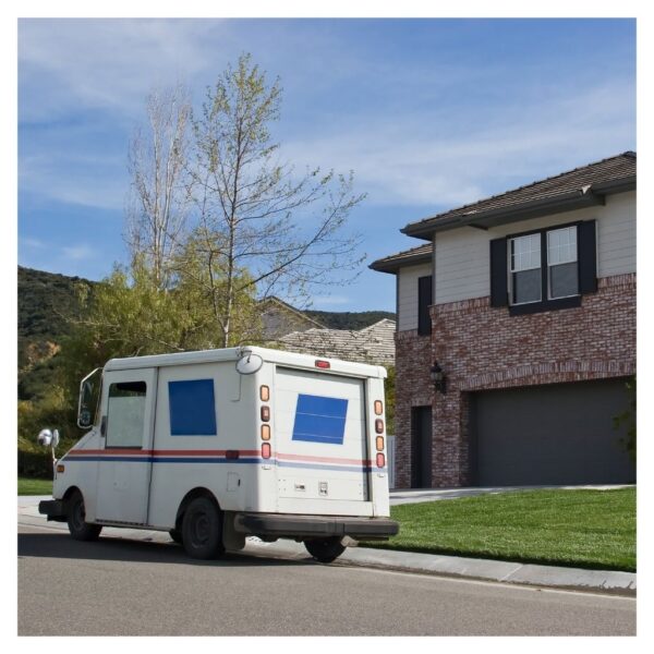 Mail truck outside of a house
