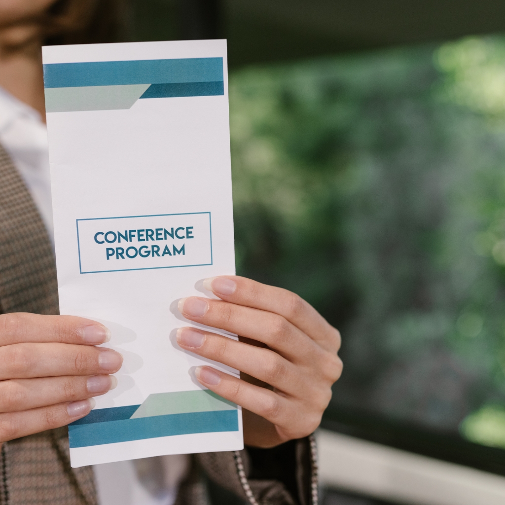 Woman holding a conference program brochure